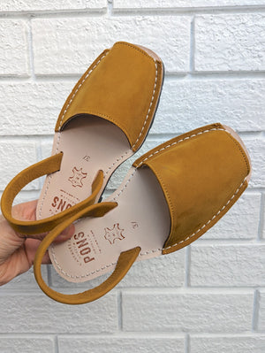 Mustard sandals on a white background
